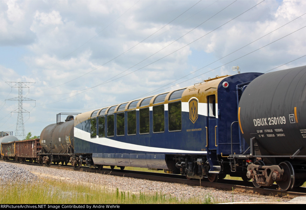 Rocky Mountaineer coach #2003 sandwiched among MPRSS' freight cars